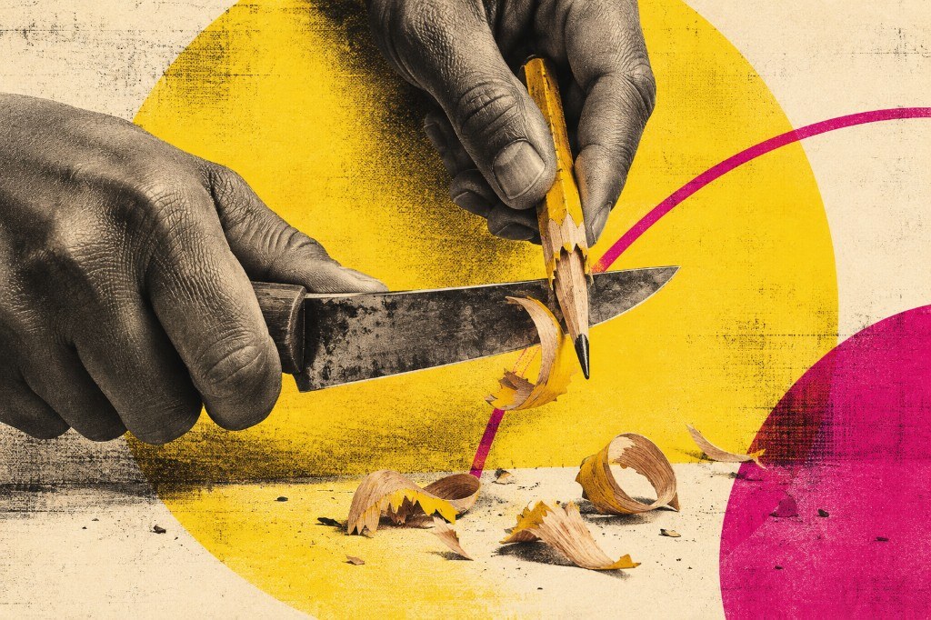 Hands sharpening a yellow pencil with a kitchen knife, with curled shavings falling below